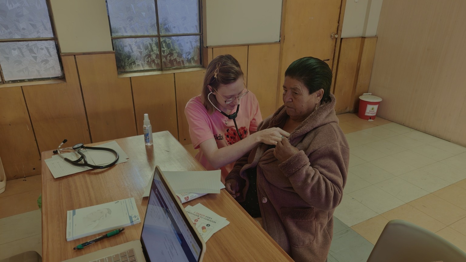 A clinician providing care during a community health visit in Ecuador